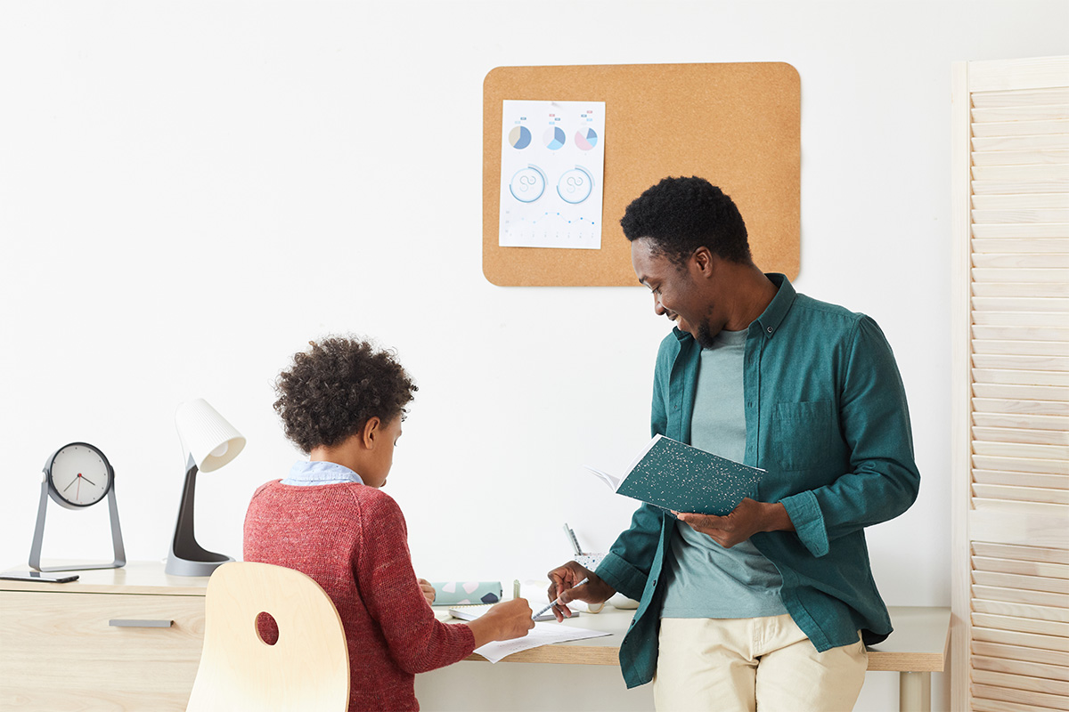 A community interpreter chats with a local teacher