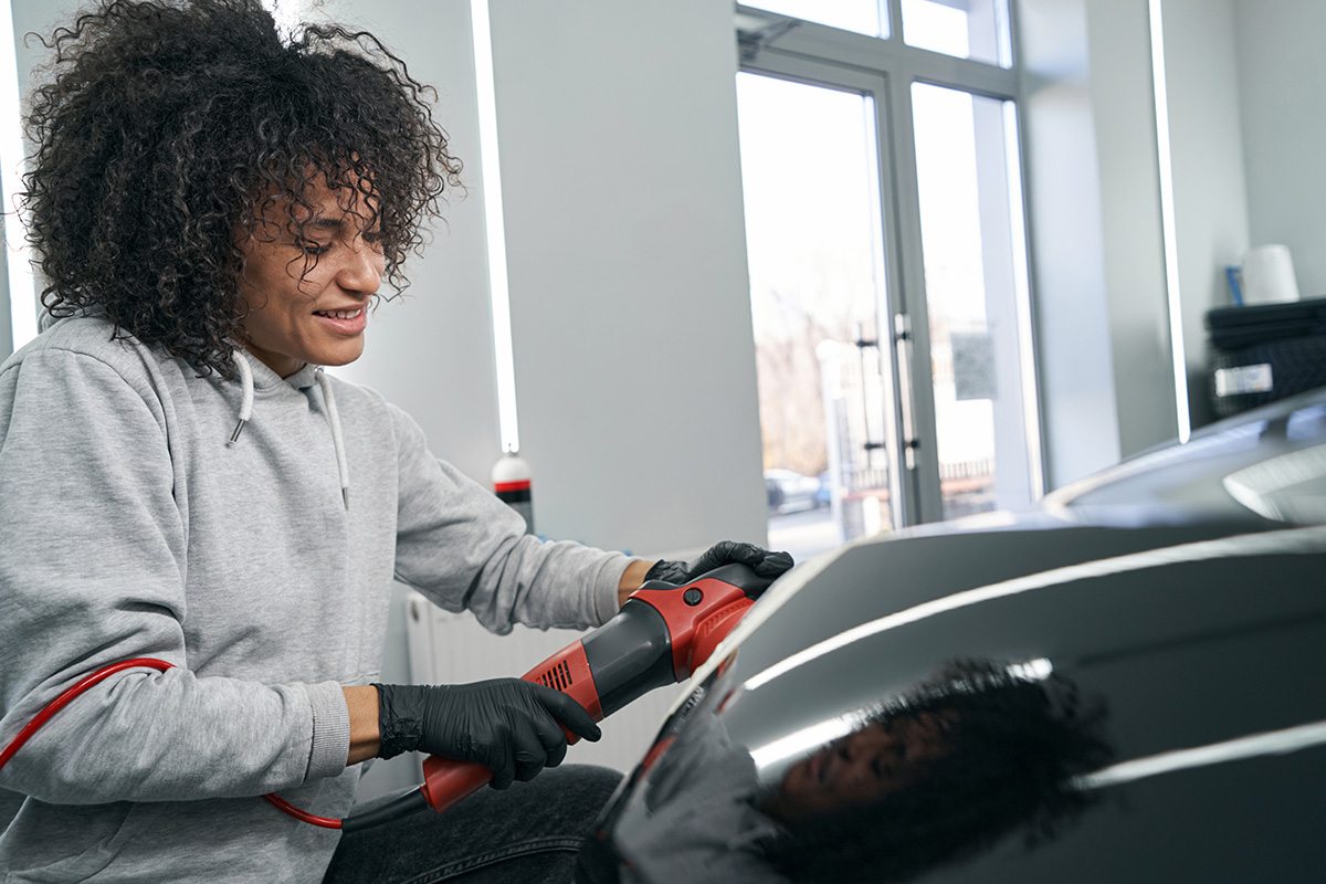 A factory worker buffs their new Electric Car