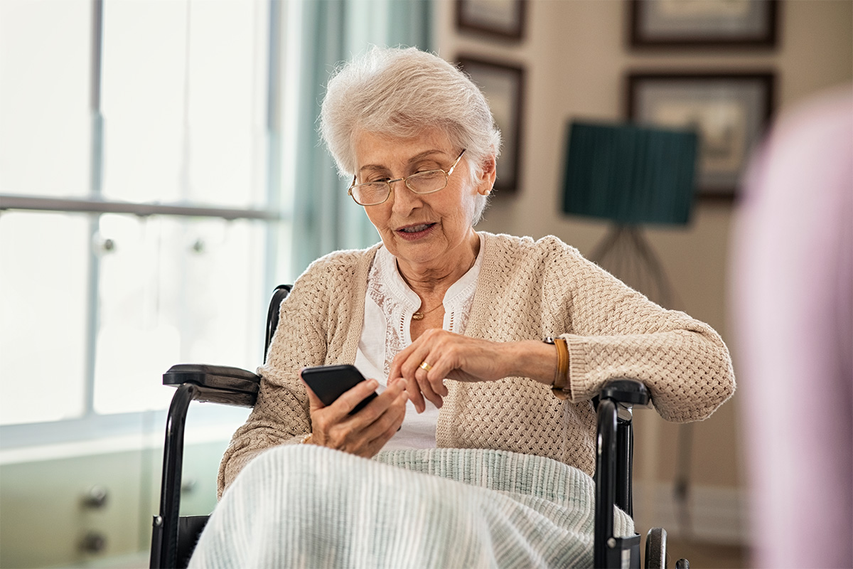 An older woman reads the medical device translation for her wheelchair.