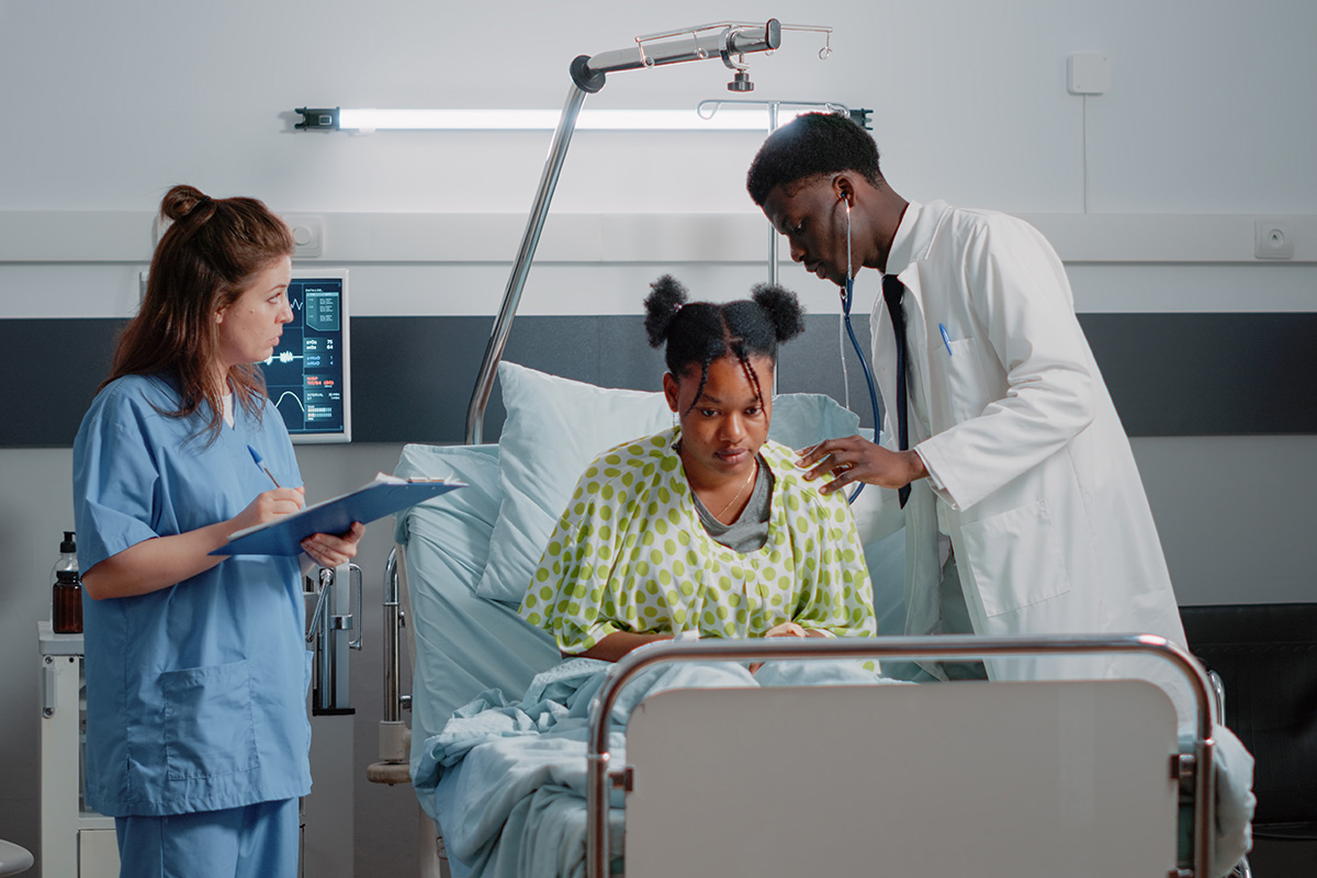 A healthcare team checks on a patient.